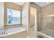 This bathroom features a soaking tub and glass shower enclosure at 4363 Summer Breeze Way, Kissimmee, FL 34744