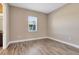 This bedroom features a window and light wood floors at 4363 Summer Breeze Way, Kissimmee, FL 34744