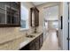 Granite countertops and dark wood cabinets featured in the butler's pantry at 4363 Summer Breeze Way, Kissimmee, FL 34744