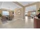 Open-concept dining room featuring tiled floors, modern lighting, and easy access to living area at 4363 Summer Breeze Way, Kissimmee, FL 34744