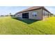 Exterior view showcasing the screened lanai and well-maintained lawn, perfect for entertaining at 4363 Summer Breeze Way, Kissimmee, FL 34744