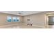 Bright living room with tile flooring, lots of natural light, and wall-mounted TV at 4363 Summer Breeze Way, Kissimmee, FL 34744