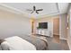 This main bedroom features wood floors, ceiling fan, tray ceiling, and a walk-in closet at 4363 Summer Breeze Way, Kissimmee, FL 34744