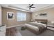 Comfortable main bedroom featuring tray ceilings, and a sitting area at 4363 Summer Breeze Way, Kissimmee, FL 34744