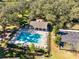 Aerial view of a refreshing community pool area with ample seating and mature trees at 4363 Summer Breeze Way, Kissimmee, FL 34744