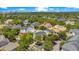 Expansive aerial view of a neighborhood with mature trees, diverse architecture, and a clear view of the city skyline at 4685 Anson Ln, Orlando, FL 32814