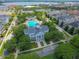 Aerial view showcases the clubhouse and pool surrounded by lush landscaping in a vibrant residential community at 4685 Anson Ln, Orlando, FL 32814