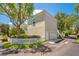 Charming home featuring a white picket fence, lush landscaping, and a private detached garage on a sunny day at 4685 Anson Ln, Orlando, FL 32814