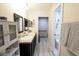 Bathroom with double vanity, walk-in closet, and gray vinyl flooring at 705 Tournament Ln, Kissimmee, FL 34759