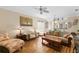 Comfortable living room featuring wood floors and an open concept layout at 8274 Bridgeport Bay Cir, Mount Dora, FL 32757