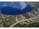 Aerial view of waterfront property with lake, road, and neighborhood at 9105 Sheen Sound St, Orlando, FL 32836