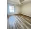 Bedroom featuring a ceiling fan, natural light from the window, and wood-look floors at 1234 Sago Palm Blvd # 1234, Kissimmee, FL 34741