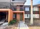Two-story residential building with orange facade and a wooden staircase at 1234 Sago Palm Blvd # 1234, Kissimmee, FL 34741