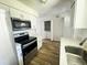 Modern kitchen with stainless appliances, white cabinets, and wood-look flooring at 1234 Sago Palm Blvd # 1234, Kissimmee, FL 34741