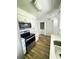 Modern kitchen with stainless appliances, white cabinets, and wood-look flooring at 1234 Sago Palm Blvd # 1234, Kissimmee, FL 34741