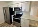 Well-equipped kitchen features stainless steel appliances and white cabinets at 1234 Sago Palm Blvd # 1234, Kissimmee, FL 34741