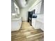 Charming kitchen with white cabinets, sleek black appliances, and stylish wood-look floors at 1234 Sago Palm Blvd # 1234, Kissimmee, FL 34741
