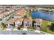 Aerial view of a residential community, showcasing well-manicured lawns, and a serene pond at 13333 Oakenshaw Ln, Orlando, FL 32832