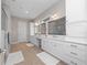 Bathroom showing double sinks, granite counters, updated white cabinets, an open shower, and tile flooring at 13333 Oakenshaw Ln, Orlando, FL 32832