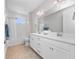 Bright bathroom featuring a double vanity with white cabinetry and marble countertops, plus a shower-tub combo at 13333 Oakenshaw Ln, Orlando, FL 32832
