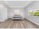 A spacious bedroom with hardwood floors, a queen bed with gray covers, a window and an overhead light at 13333 Oakenshaw Ln, Orlando, FL 32832