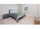 Comfortable bedroom featuring neutral carpet, complemented by a cozy bed, side table, and a bright window at 13333 Oakenshaw Ln, Orlando, FL 32832