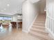 Inviting entryway featuring an open floor plan, tile flooring, stairs, and a modern kitchen with a breakfast bar at 13333 Oakenshaw Ln, Orlando, FL 32832