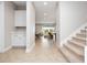 Inviting foyer with tile flooring, staircase, and views into the open-concept living spaces at 13333 Oakenshaw Ln, Orlando, FL 32832