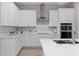 Modern kitchen featuring white cabinets, stainless steel appliances, and sleek countertops at 13333 Oakenshaw Ln, Orlando, FL 32832