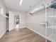 Spacious walk-in closet with laminate floors, bright lighting, adjustable shelving for optimized storage solutions at 13333 Oakenshaw Ln, Orlando, FL 32832