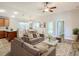 Bright living room with open floor plan, hardwood floors, and stylish furniture at 548 Coral Trace Blvd, Edgewater, FL 32132