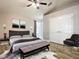 Spacious main bedroom with plush bed, large closet, and wood floors at 548 Coral Trace Blvd, Edgewater, FL 32132