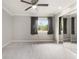 Bedroom with neutral carpet, ceiling fan and large mirrored closet doors at 5929 Windhover Dr # A02, Orlando, FL 32819