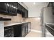Kitchen featuring stainless steel appliances, dark cabinetry, and tile backsplash at 5929 Windhover Dr # A02, Orlando, FL 32819