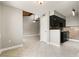 Spacious living room open to kitchen with tile floors and vaulted ceiling with ceiling fan at 5929 Windhover Dr # A02, Orlando, FL 32819