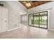 Bright living room featuring tile floors, wood vaulted ceiling, and sliding glass doors to the outside at 5929 Windhover Dr # A02, Orlando, FL 32819