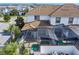 An elevated view showcases a home's tile roof and screened pool area within the community's attractive residential landscape at 1574 Slice Way, Davenport, FL 33896