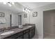Bathroom with a double vanity, granite countertop, lighting and framed art at 1574 Slice Way, Davenport, FL 33896