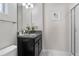 Bathroom vanity with framed art above the toilet and a glass shower at 1574 Slice Way, Davenport, FL 33896
