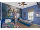 bedroom featuring an Avengers mural and twin beds at 1574 Slice Way, Davenport, FL 33896