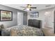 Bedroom featuring a bed, ceiling fan, dresser, and ensuite bathroom at 1574 Slice Way, Davenport, FL 33896
