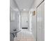 Bright hallway featuring a glass table, tiled floor, and white doors, leading to other areas of the house at 1574 Slice Way, Davenport, FL 33896