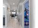 Neutral hallway with views of a bedroom and dining area, enhanced by modern flooring and recessed lighting at 1574 Slice Way, Davenport, FL 33896