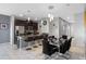 Open-concept kitchen and dining area with modern lighting and dark wood cabinets at 1574 Slice Way, Davenport, FL 33896