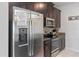 Kitchen with stainless steel appliances and dark wood cabinets at 1574 Slice Way, Davenport, FL 33896