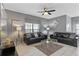 Comfortable living room with two leather sofas, stylish decor, and plenty of natural light at 1574 Slice Way, Davenport, FL 33896
