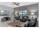 Cozy living room featuring leather sofas, decorative lighting, and a mounted television for entertainment at 1574 Slice Way, Davenport, FL 33896