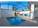 Private backyard pool with patio and ample seating under a screened enclosure at 1574 Slice Way, Davenport, FL 33896