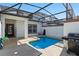 Screened in swimming pool area with a patio table and grill at 1574 Slice Way, Davenport, FL 33896