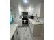 Renovated kitchen with white cabinets and quartz countertops at 1625 Hastings Dr, Deltona, FL 32725